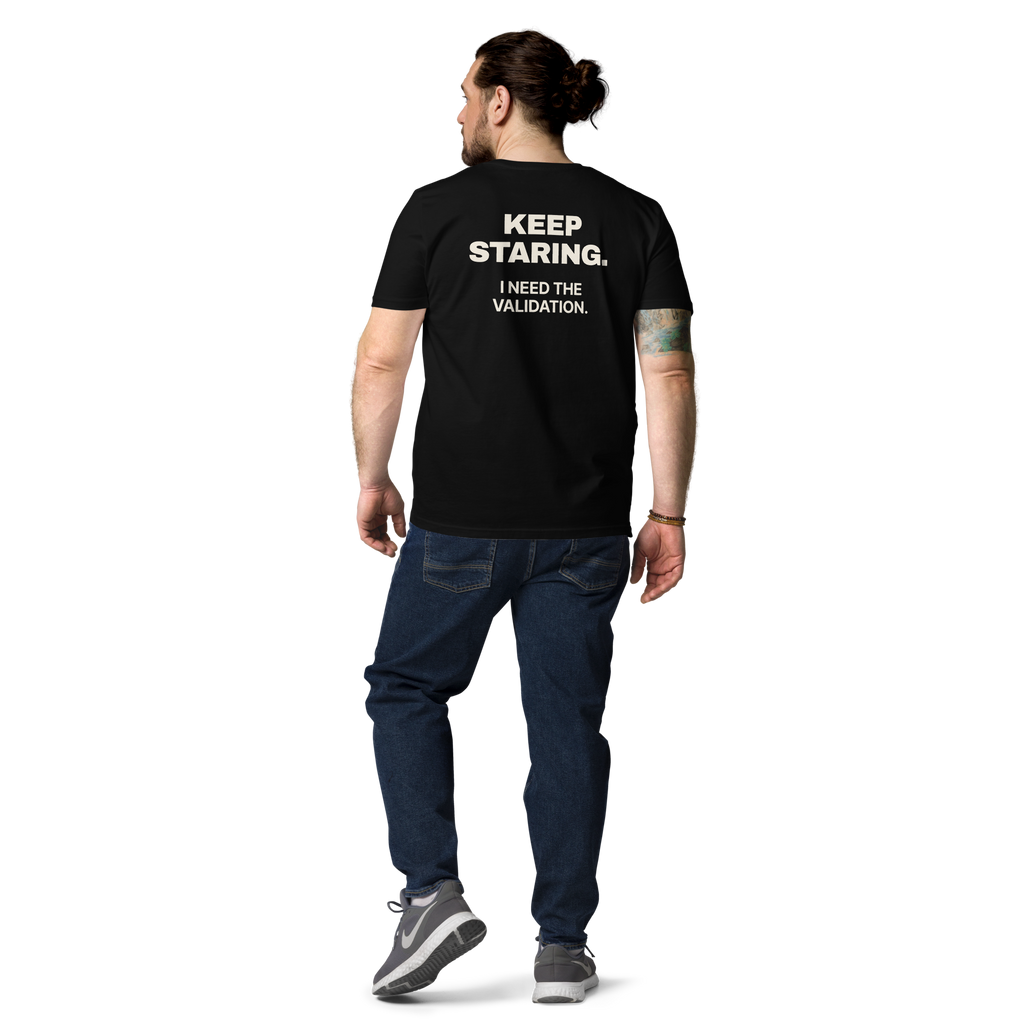 Man wearing the Keep Staring. I Need the Validation T-shirt in black, back view