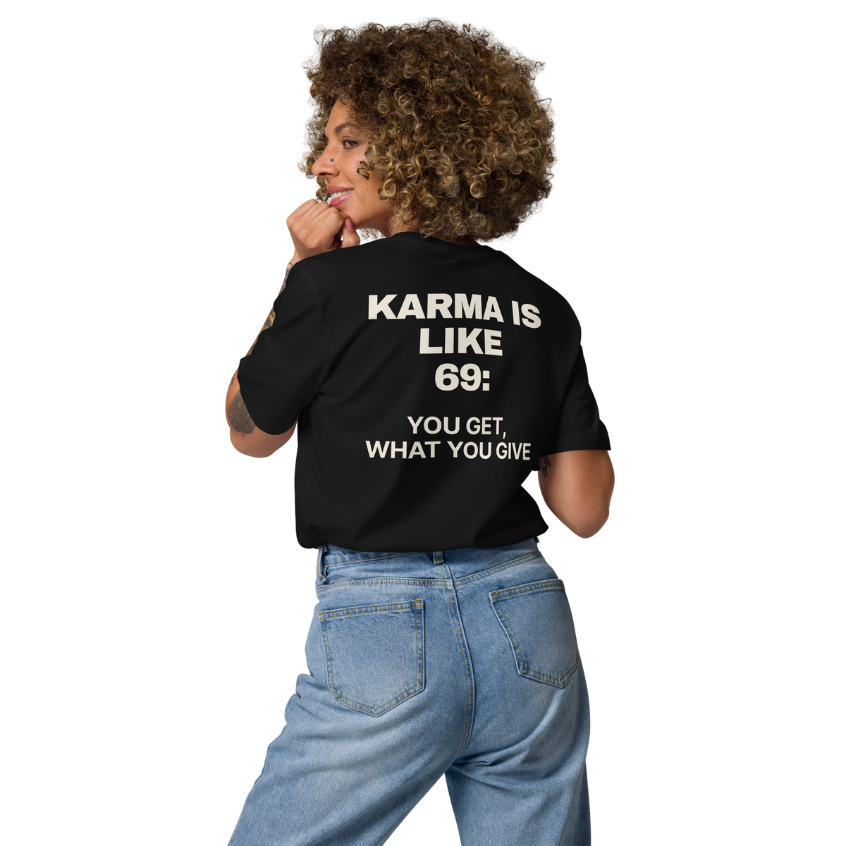 Woman wearing the Karma Is Like 69: You Get What You Give T-shirt in black, back view