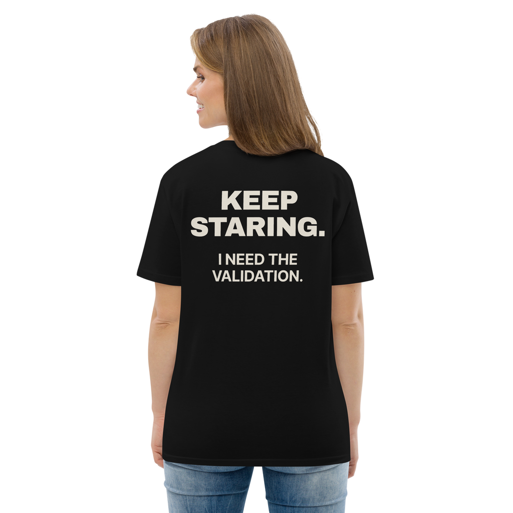 Woman wearing the Keep Staring. I Need the Validation T-shirt in black, back view