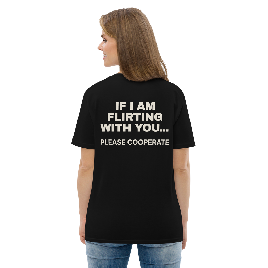 Woman wearing the If I Am Flirting with You… Please Cooperate T-shirt in black, back view