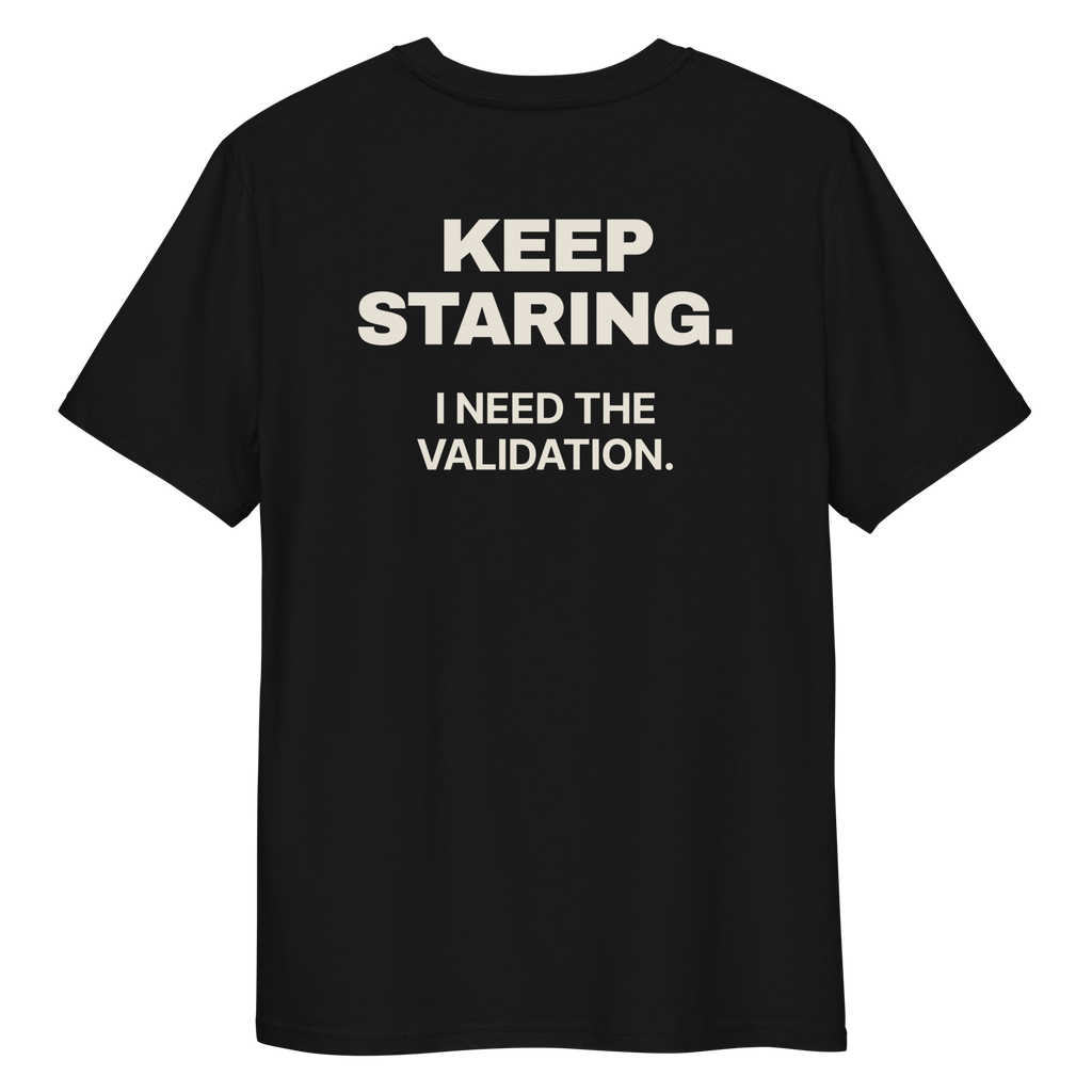 Close-up of the Keep Staring. I Need the Validation print on a black T-shirt, back view