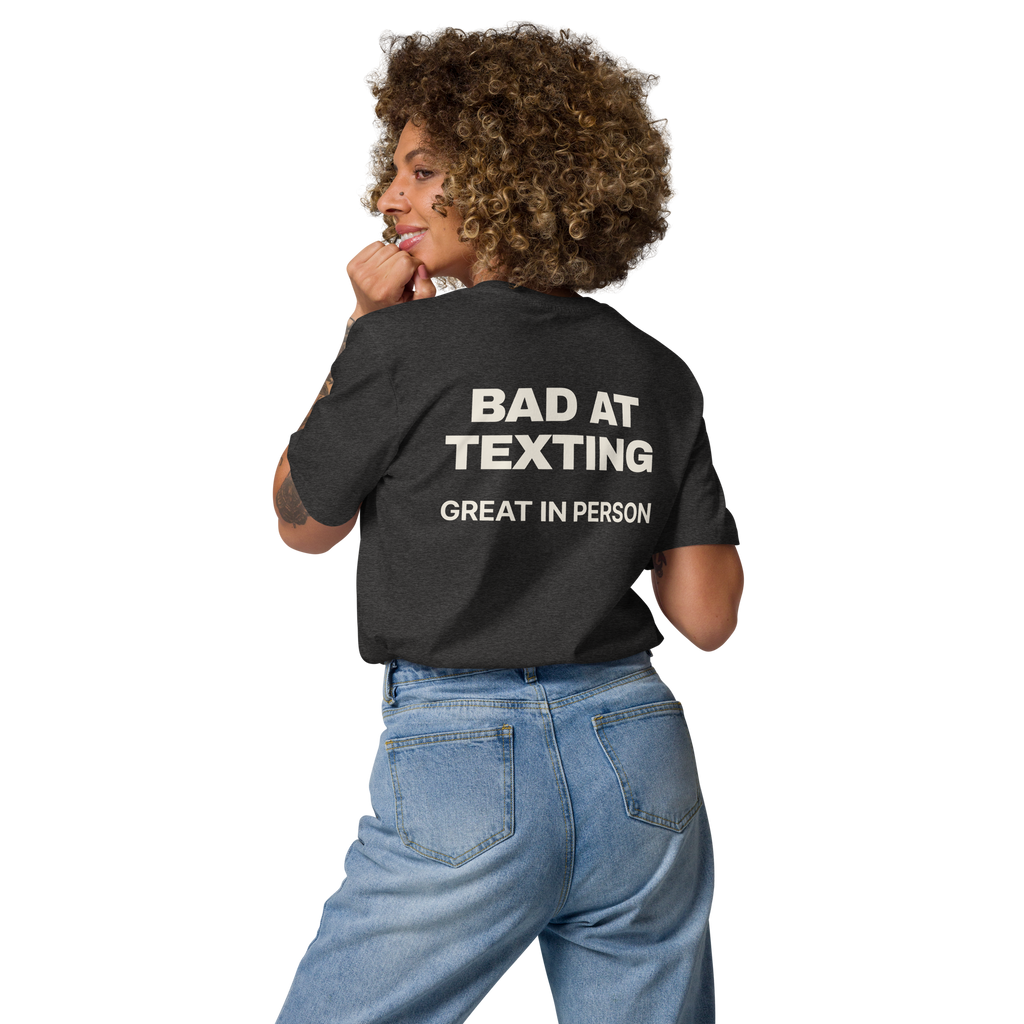 Woman wearing the Bad at Texting, Great in Person T-shirt in dark heather grey, back view
